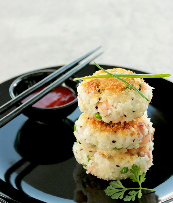 Chinese fried rice cakes served with shriracha sauce.