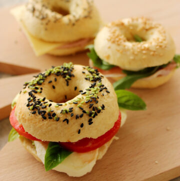 homemade mini bagels stuffed with tomato, mozzarella and basil leaves.