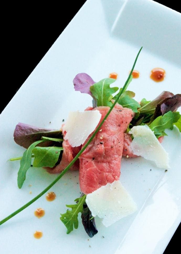 italian beef carpaccio with parmesan shavings and dijon vinaigrette.