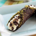 A sweet fried crispy dough dipped in dark chocolate and filled with the most fresh citrusy ricotta cheese, bits of dark chocolate and pistachios. Cannoli are the most famous Sicilian dessert in the world! Recipe from The Petite Cook