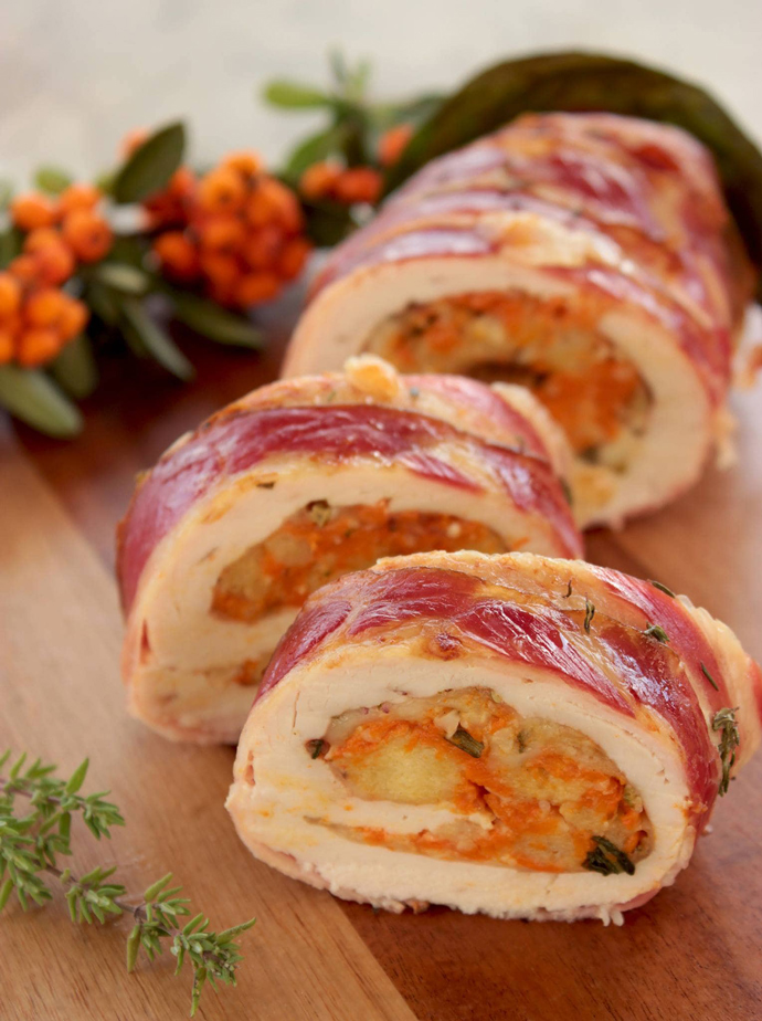 Turkey roulade with Pumpkin & Cranberry stuffing sliced on a chopping board