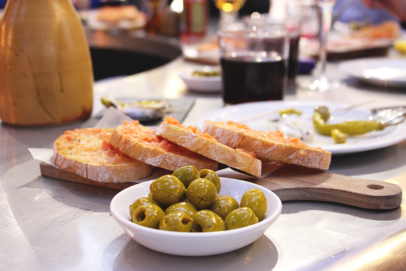 Sangria served with Andalusian style olives and Pan con Tomate, roasted bread rubbed with tomatoes and olive oil.