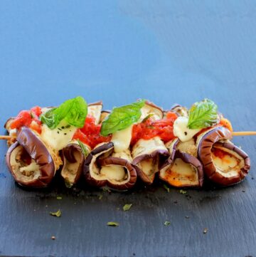 Eggplant Parmigiana Skewers topped with mozzarella and cubed tomato.