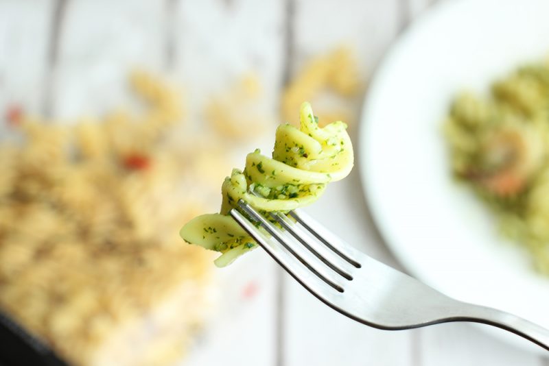 fork holding a fusilli pasta with rocket pesto