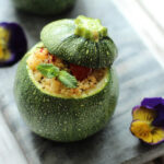 one couscous salad stuffed round zucchini.