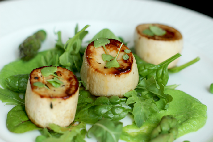 vegan scallops with pea pesto, baby salad leaves and asparagus.