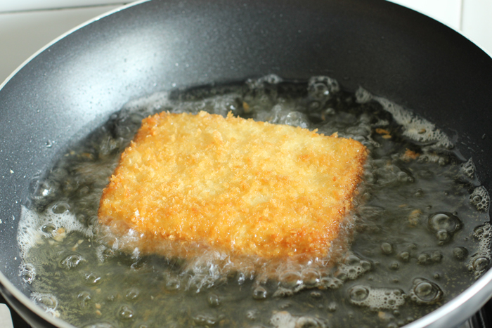 fried mozzarella sandwich prep step 6: sandwich frying in large pan with hot oil