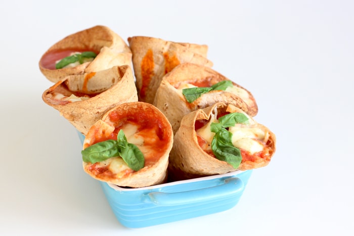 tortilla pizza cones stuffed with marinara sauce, mozzarella and basil leaves.