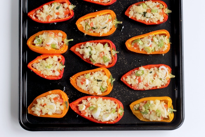 couscous stuffed mini peppers on a baking tray