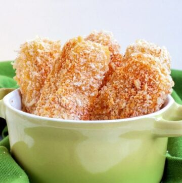 baked mozzarella sticks in a small plate ready to serve