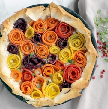 This light and vibrant maple-glazed carrot phyllo tart is packed with seasonal rainbow carrots and fresh aromatic ricotta cheese - Ready in just 20 mins and 8 ingredients, it makes a showstopping vegetarian appetizer or main to share. Perfect for holiday parties! Recipe from www.thepetitecook.com