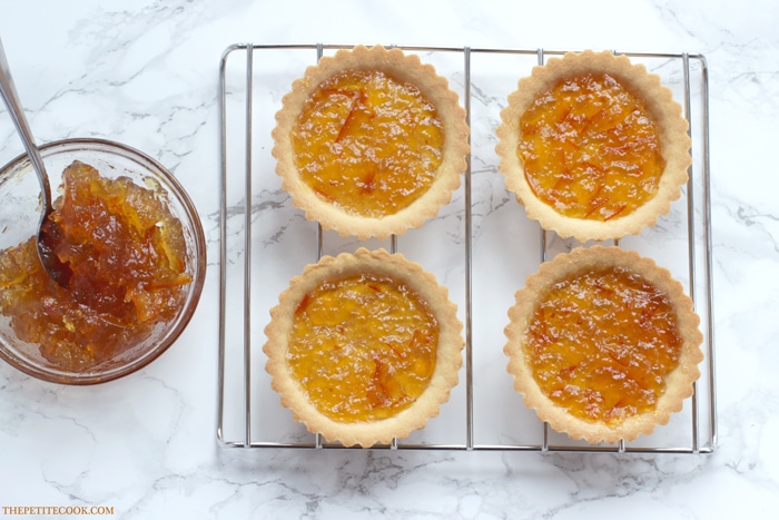 This delicious Mini Jaffa Tarts give a new twist to a classic British treat. The indulgent chocolate and orange combo makes a great dinner party dessert. Recipe from www.thepetitecook.com