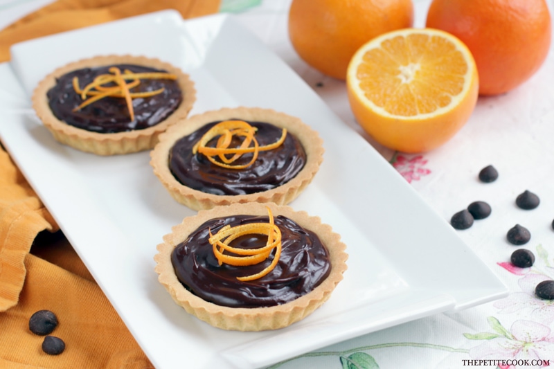 This delicious Mini Jaffa Tarts give a new twist to a classic British treat. The indulgent chocolate and orange combo makes a great dinner party dessert. Recipe from www.thepetitecook.com