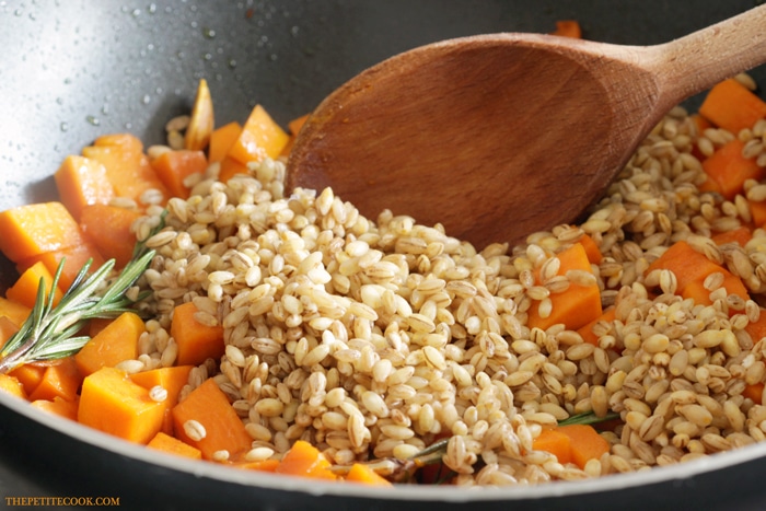 recipe step 2: barley stirred into the skillet with the rosemary, garlic and pumpkin cubes.