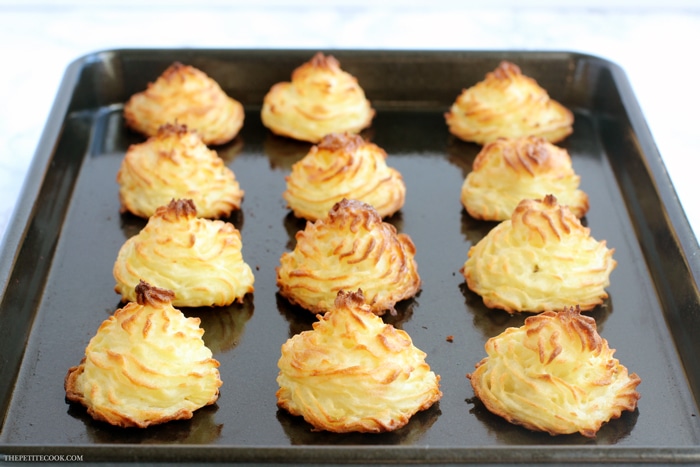 recipe step 3: cooked duchess potatoes on baking tray, ready to serve