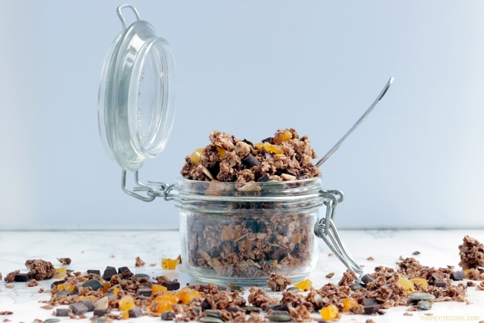 Delicious, easy, healthy, wholesome, Homemade Chocolate Granola. Vegan, gluten-free and better than store-bought, this crunchy mix of oats, healthy nuts & seeds and chocolate is the best way to start your day. Recipe from www.thepetitecook.com