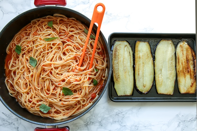 Eggplant spaghetti sandwichesprocess: pot wioth spaghetti and tomato sauce next to baking tray with cooked eggplant slices