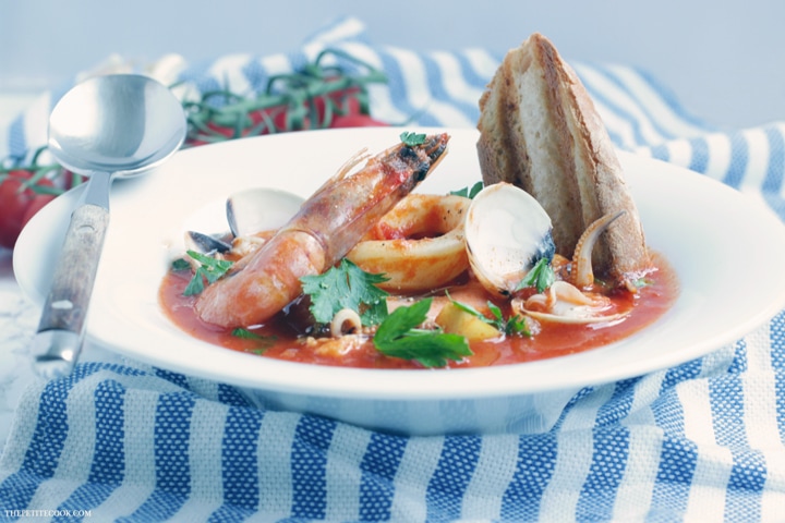 This simple Seafood Bouillabaisse is love at first spoon - Filled with aromatic Mediterranean flavors infused in a delicate saffron aroma, this light and easy version is ready in 30 mins and naturally gluten-free and dairy-free. Recipe from www.thepetitecook.com