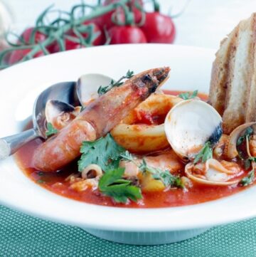 This simple Seafood Bouillabaisse is love at first spoon - Filled with aromatic Mediterranean flavors infused in a delicate saffron aroma. This light and easy version is ready in 30 mins and makes the most of seasonal ingredients for a simple and elegant heart-warming meal. Recipe from www.thepetitecook.com