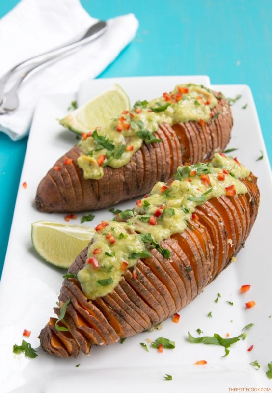 The easiest way to upgrade your typical baked potatoes. Crispy outside and fluffly melt-in-your mouth within, these Hasselback Sweet Potatoes with Guacamole make a great vegetarian spring or/and summer side! Recipe from www.thepetitecook.com