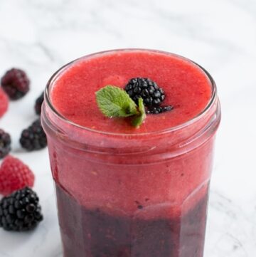 A double-layer of nutritious berry goodness that instantly cheers you up - This Frozen Double Berry Smoothie is the perfect drink to complement spring and summer breakfasts. Vegan and Gluten-free recipe from www.thepetitecook.com