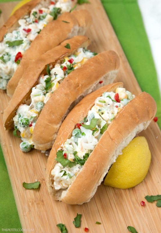 three lobster rolls served on a wood board