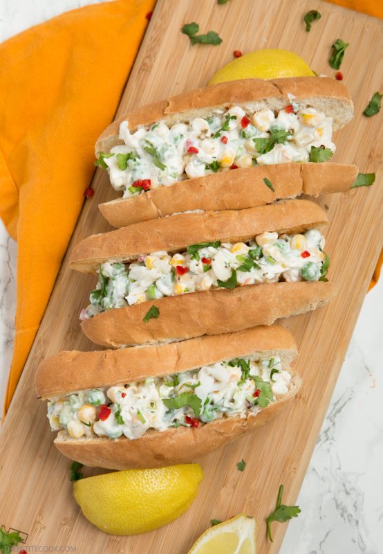 three lobster rolls on a wood board