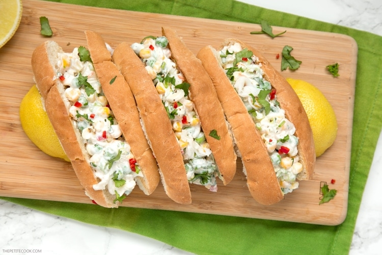 three summer lobster rolls on a wood board