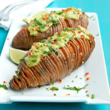 The easiest way to upgrade your typical baked potatoes. Crispy outside and fluffly melt-in-your mouth within, these Hasselback Sweet Potatoes with Guacamole make a great vegetarian spring or/and summer side! Recipe from www.thepetitecook.com