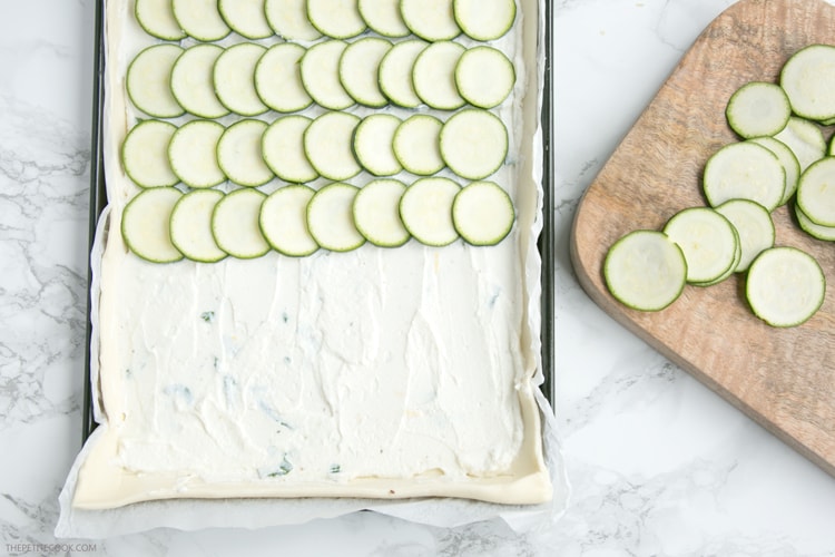 This rustic Zucchini Tart with Ricotta and Fresh Herbs makes a tasty vegetarian meal for any occasion - Ready in 30 mins and requiring just 5 ingredients, it's the perfect addition to any summer table! Recipe from www.thepetitecook.com