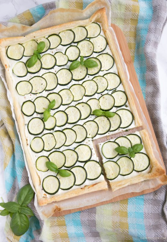 This rustic Zucchini Tart with Ricotta and Fresh Herbs makes a tasty vegetarian meal for any occasion - Ready in 30 mins and requiring just 5 ingredients, it's the perfect addition to any summer table! Recipe from www.thepetitecook.com