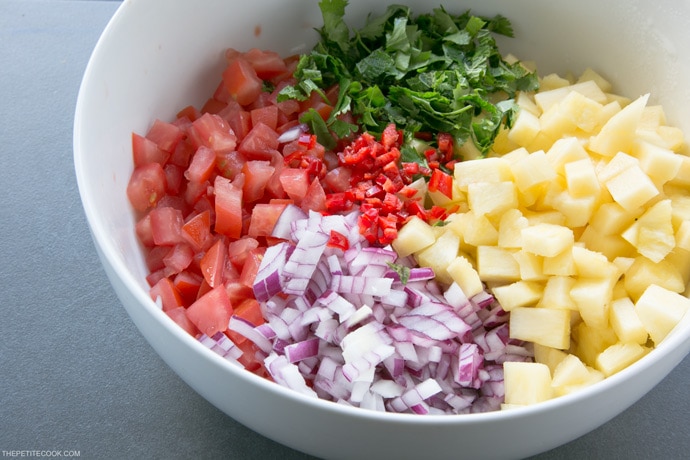 A delicious combo of sweet & spicy flavors makes this Easy Pineapple Salsa just the perfect side for any grilled meat or fish! Recipe from www.thepetitecook.com