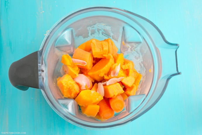 pumpkin, onion, carrots in the jug of a vitamix