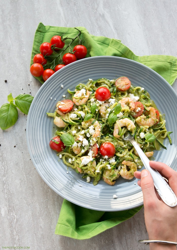 A new twist on a classic summer Italian dish without all the carbs - These Pesto Zucchini Noodles With Shrimps have the same flavors, same tastiness but totally gluten-free and so much healthier and lighter! Recipe from www.thepetitecook.com