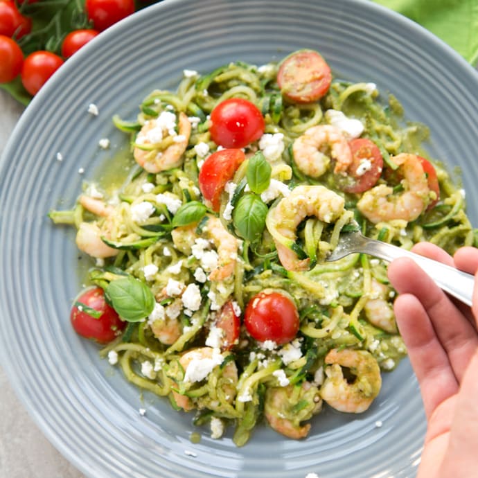 A new twist on a classic summer Italian dish without all the carbs - These Pesto Zucchini Noodles With Shrimps have the same flavors, same tastiness but totally gluten-free and so much healthier and lighter! Recipe from www.thepetitecook.com