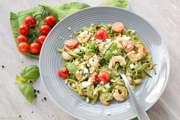 A new twist on a classic summer Italian dish without all the carbs - These Pesto Zucchini Noodles With Shrimps have the same flavors, same tastiness but totally gluten-free and so much healthier and lighter! Recipe from www.thepetitecook.com