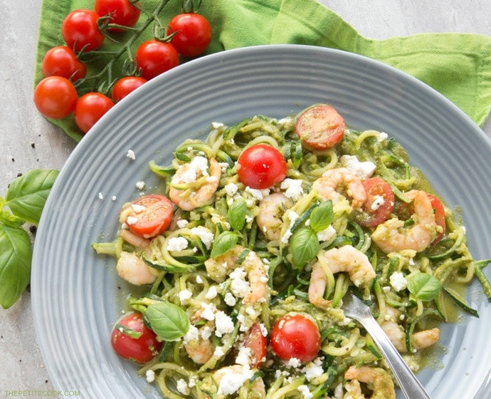 A new twist on a classic summer Italian dish without all the carbs - These Pesto Zucchini Noodles With Shrimps have the same flavors, same tastiness but totally gluten-free and so much healthier and lighter! Recipe from www.thepetitecook.com