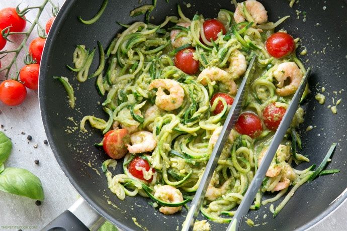 A new twist on a classic summer Italian dish without all the carbs - These Pesto Zucchini Noodles With Shrimps have the same flavors, same tastiness but totally gluten-free and so much healthier and lighter! Recipe from www.thepetitecook.com
