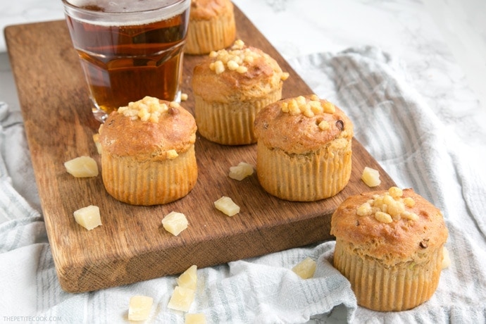 These Cheesy Parmesan Beer Muffins are a great grab-and-go snack or make-ahead lunchbox option - Super fluffy, packed with flavors, vegetarian and no butter or eggs required! Recipe from www.thepetitecook.com