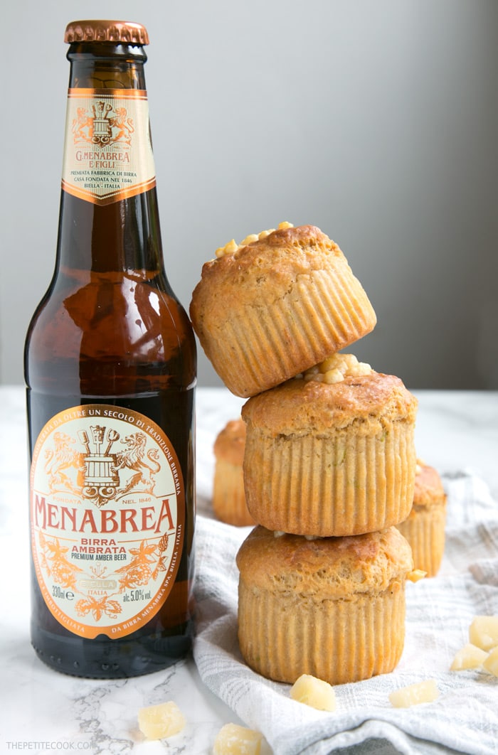 These Cheesy Parmesan Beer Muffins are a great grab-and-go snack or make-ahead lunchbox option - Super fluffy, packed with flavors, vegetarian and no butter or eggs required! Recipe from www.thepetitecook.com