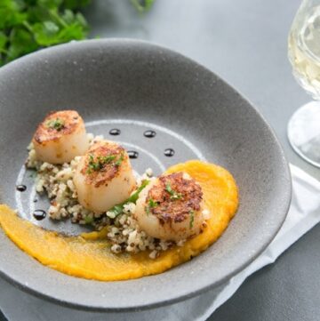 Packed with nutrients and bold vibrant flavors, these Spicy Scallops with Pumpkin Puree make a great gluten-free starter, and are sure to steal the show at your next dinner party! #glutenfree #seafood #pumpkin www.thepetitecook.com