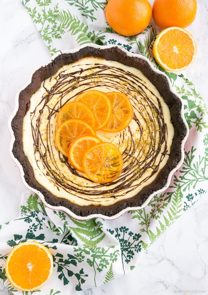 A crispy chocolatey gluten-free crust paired beautifully with a sweet and tangy ricotta and orange filling - This Orange Chocolate tart is a the perfect dessert for a fall afternoon treat.