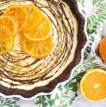A crispy chocolatey gluten-free crust paired beautifully with a sweet and tangy ricotta and orange filling - This Orange Chocolate tart is a the perfect dessert for a fall afternoon treat.