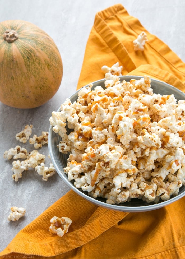 Salty, sweet, lightly spiced and crunchy, this super quick Caramel Pumpkin Spice Popcorn is sure to become your new favorite movie buddy! Recipe from www.thepetitecook.com