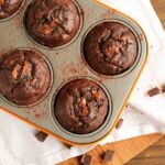 Soft, rich and extra chocolaty - These low fat Double Chocolate Banana Bread Muffins don't require extra refined sugar, oil or butter but are crazy moist and loaded with banana and chocolate flavor. Recipe from www.thepetitecook.com