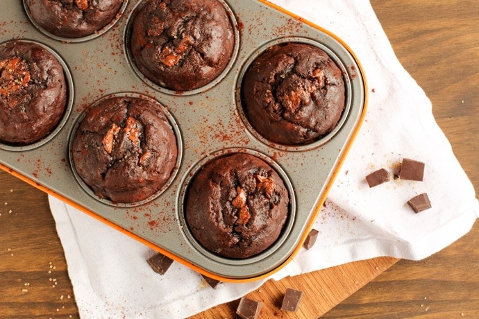 Soft, rich and extra chocolaty - These low fat Double Chocolate Banana Bread Muffins don't require extra refined sugar, oil or butter but are crazy moist and loaded with banana and chocolate flavor. Recipe from www.thepetitecook.com