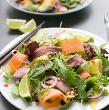 Bursting with flavors, this gluten-free Asian Beef Salad is ready in just 15 min and loaded with protein-rich beef, healthy veggies and fresh herbs - The perfect balanced meal to enjoy on a busy day! Recipe from The Petite Cook