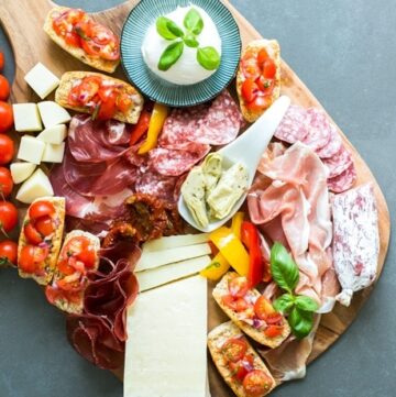 Italian Aperitivo Platter - Planning an al fresco event to entertain your guests this summer? Look no further - It really doesn’t get easier (and tastier) than Italian aperitivo, with tasty cheeses, charcuterie, vegetables and fruit. Recipe by The Petite Cook