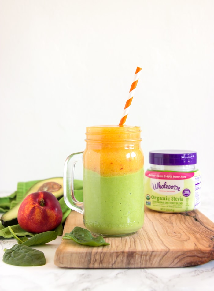 nectarine and avocado smoothie in a drinking jar over a wood board, next to wholesome stevia package, nectarine and avocado