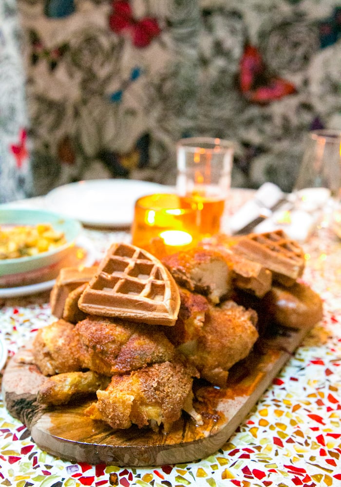 chicken and waffles on a wood board